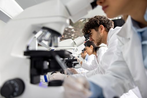 medical student looking through a microscope at the laboratory